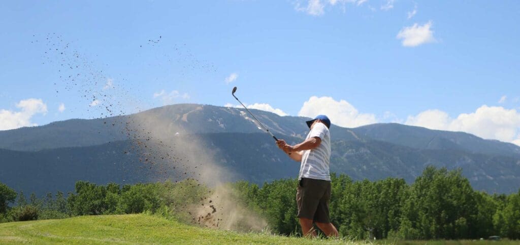 header.img man hitting golf ball out of sand trap red lodge mountain golf course montana 15 Best Things To Do in Red Lodge, Montana